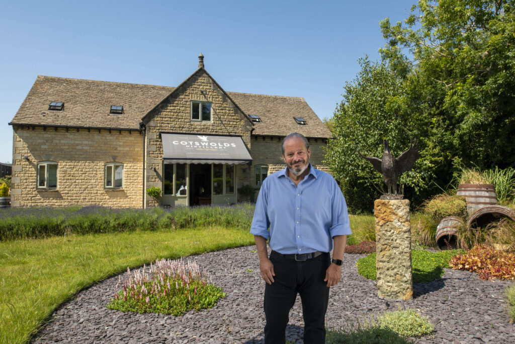 Man in front of Cotswold stone HQ