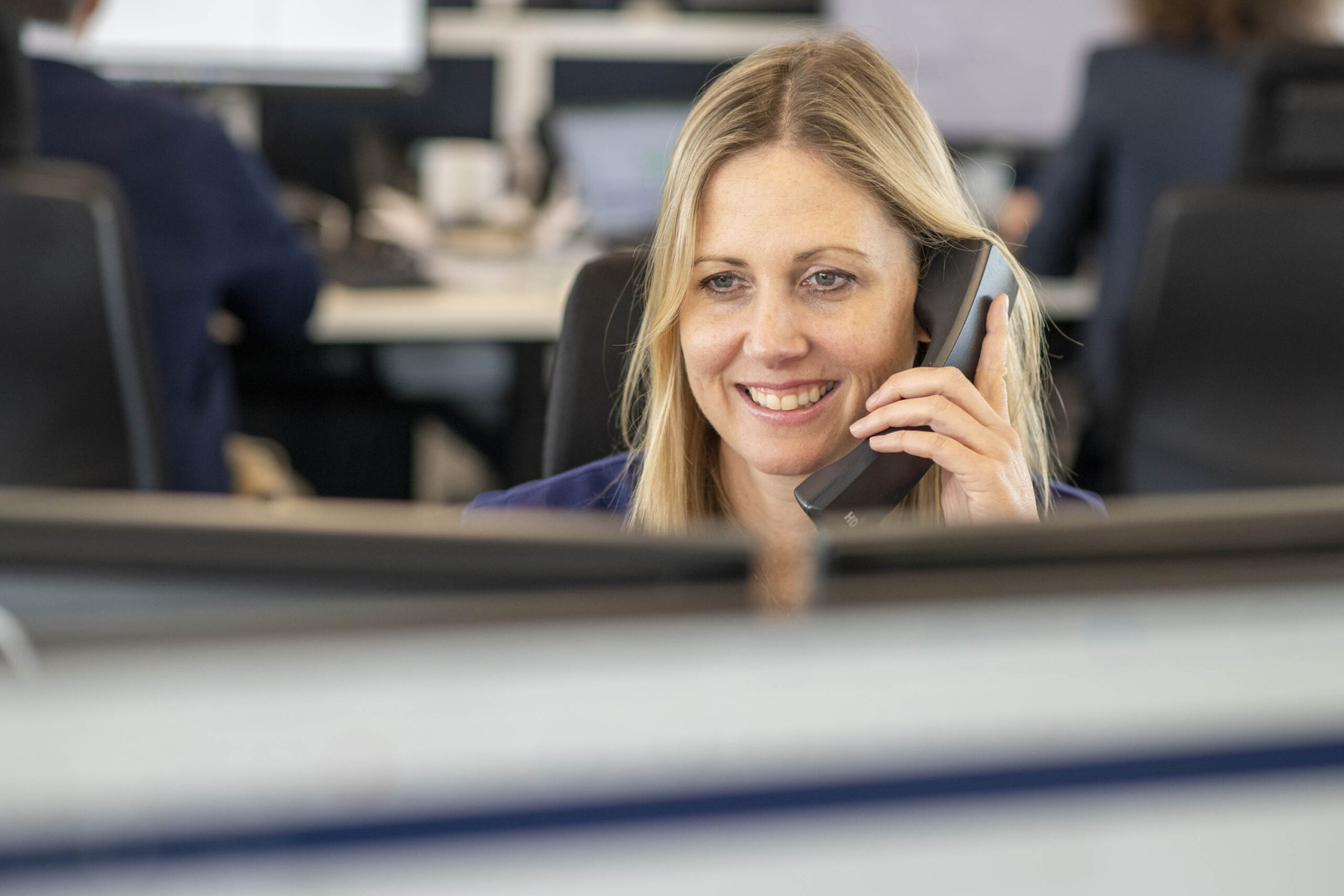 lady on phone in trading office