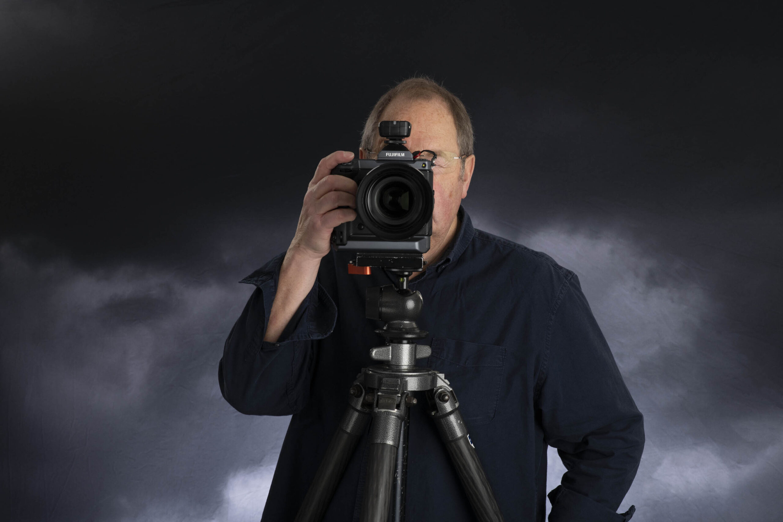 Lorentz Gullachsen hidden behind camera with Stormy sky background