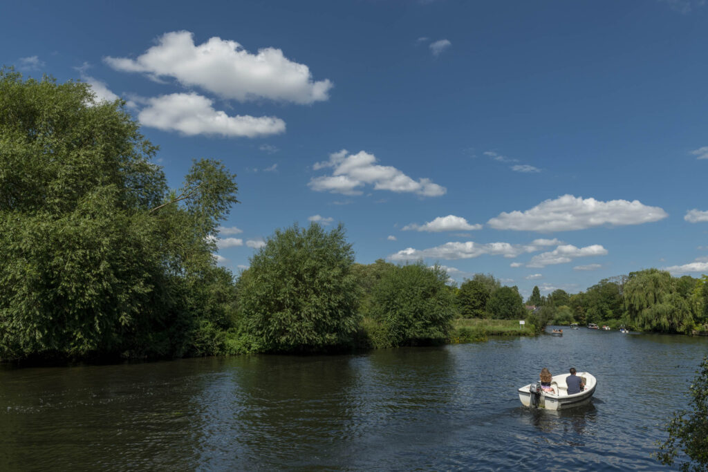 couple in boat on river with blue sky