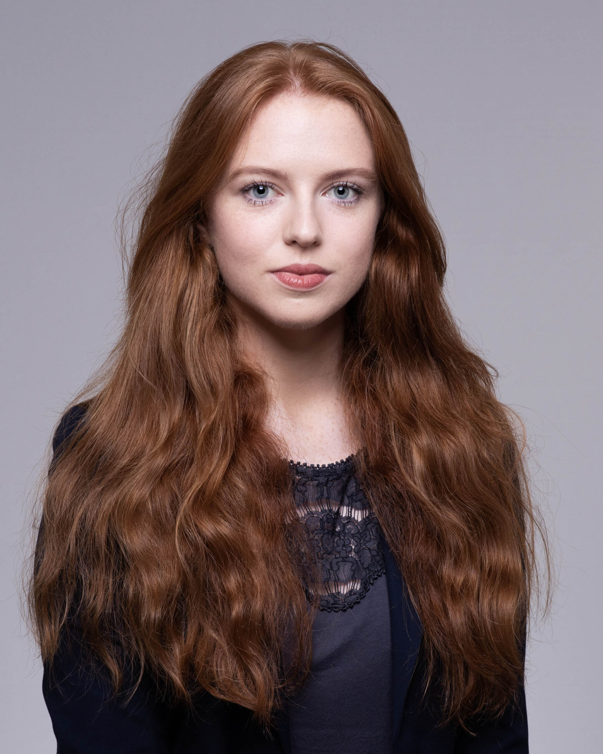 Chestnut hair young lady direct to camera headshot