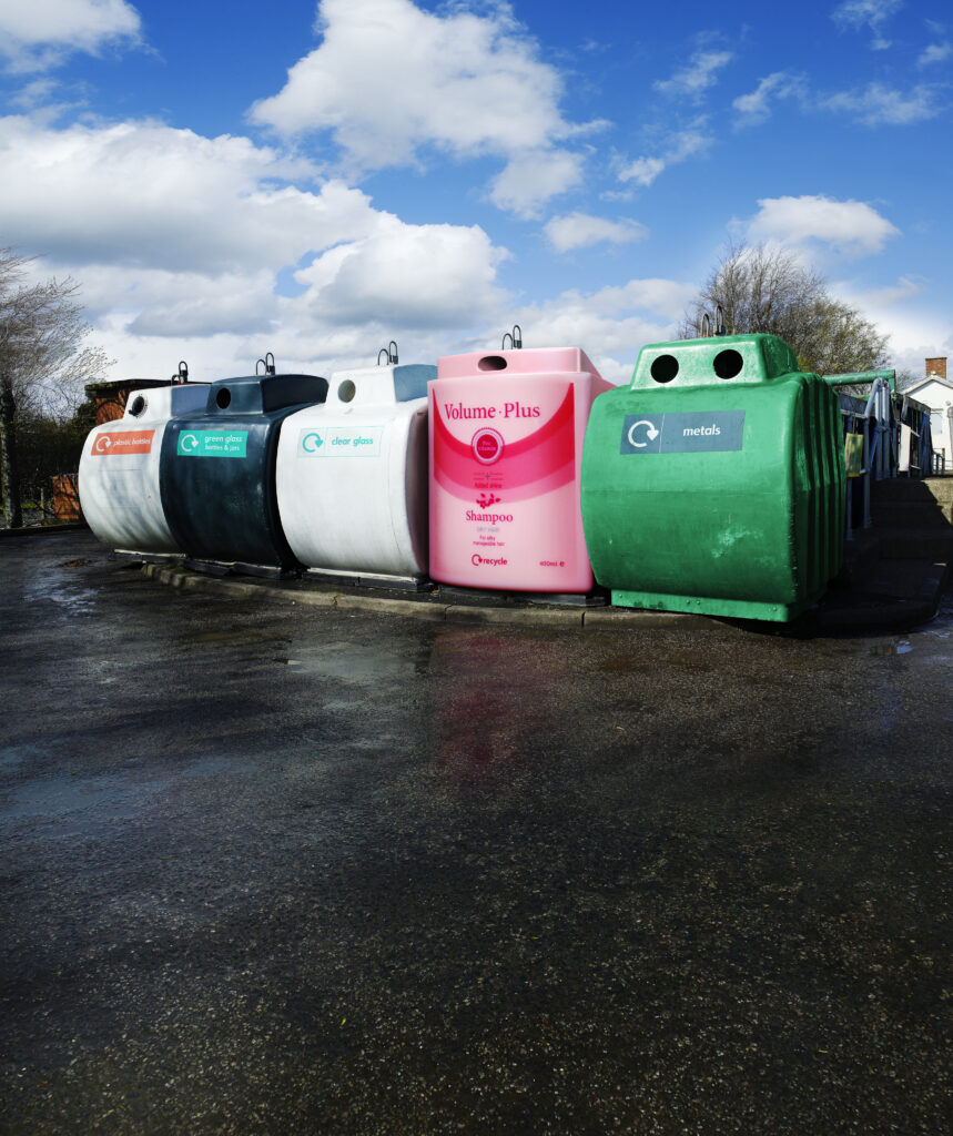 recycling centre bins for waste including one made to look like a massive shampoo bottle
