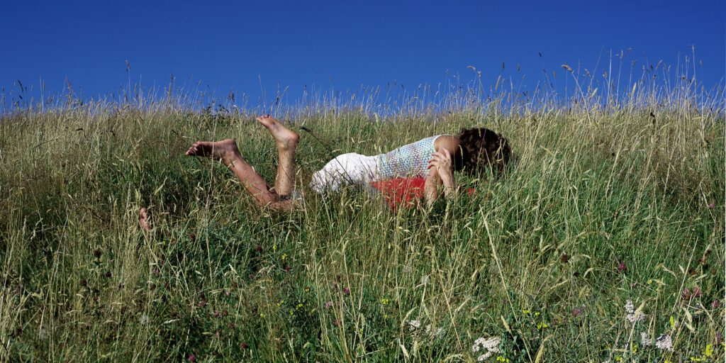 embracing couple in meadow with flowers -