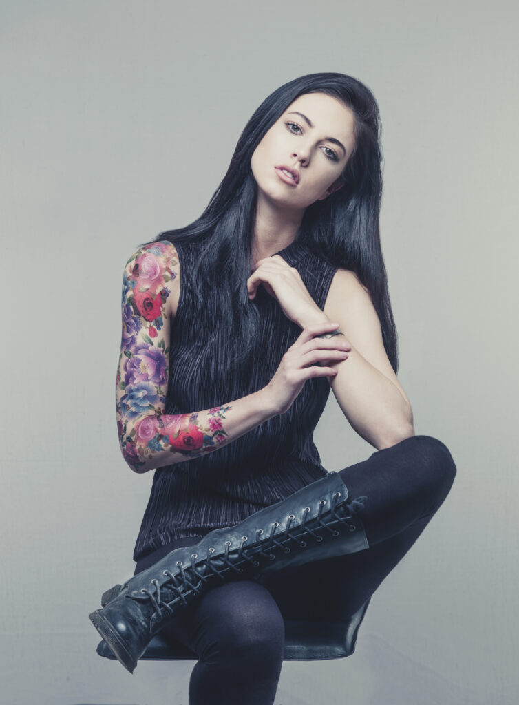 Young woman with Flower Tattoo on arm