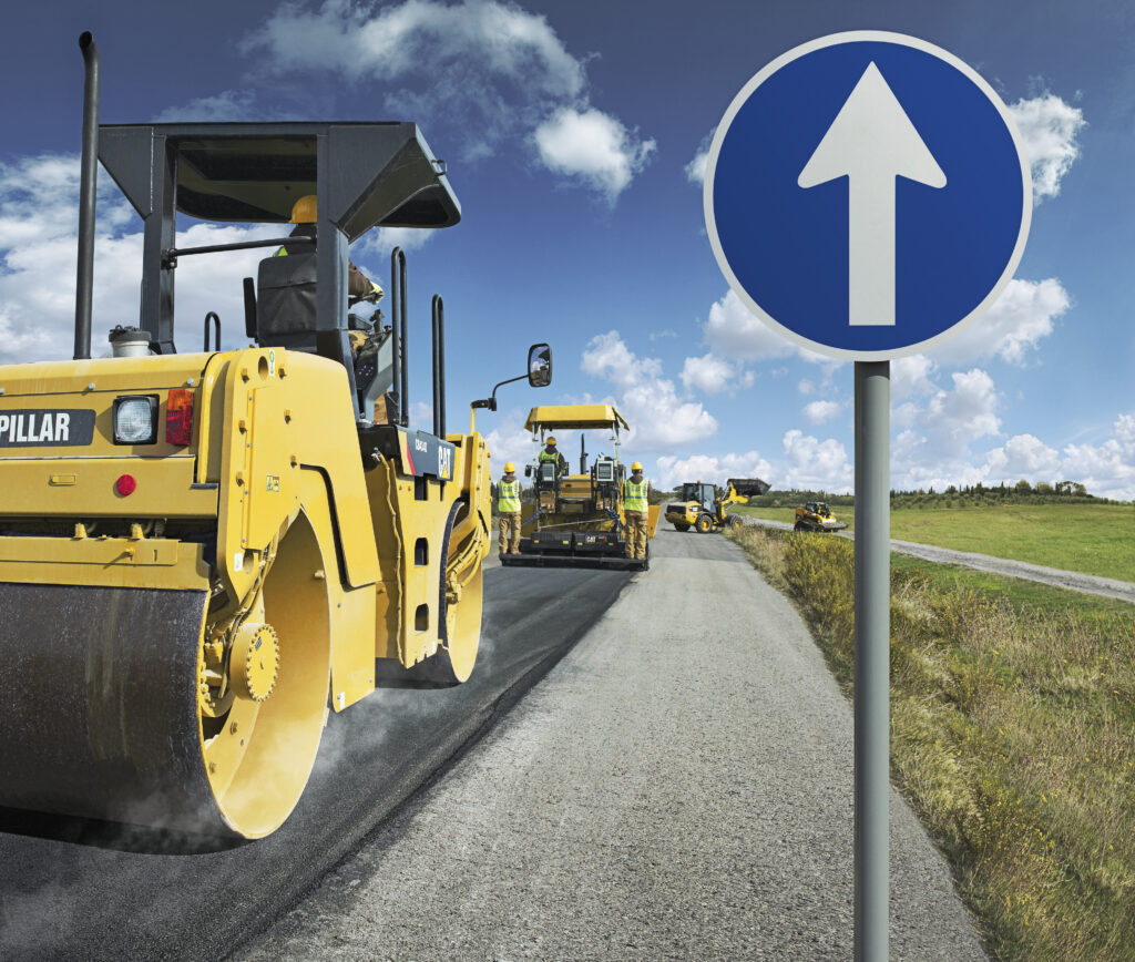 roadsign, caterpillar roller and road workers