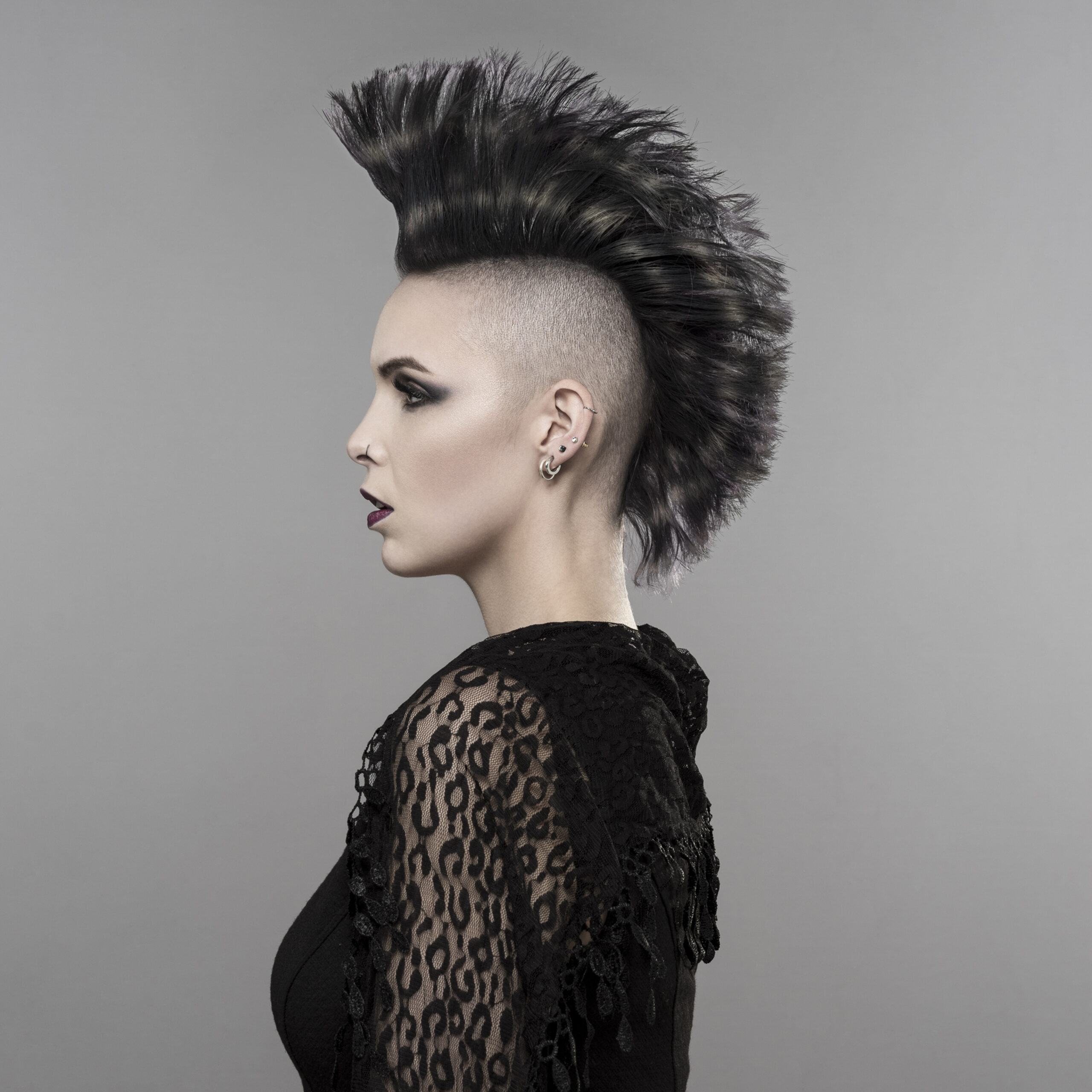 Goth girl with Mohican hairstyle seen from side