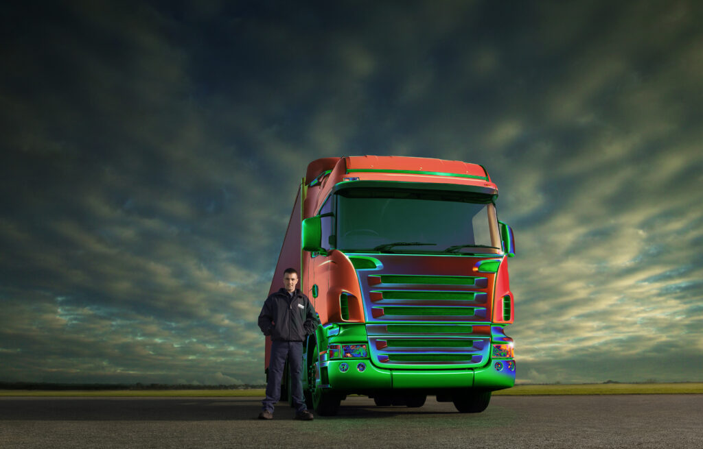 driver in front of CGI truck that looks futuristic