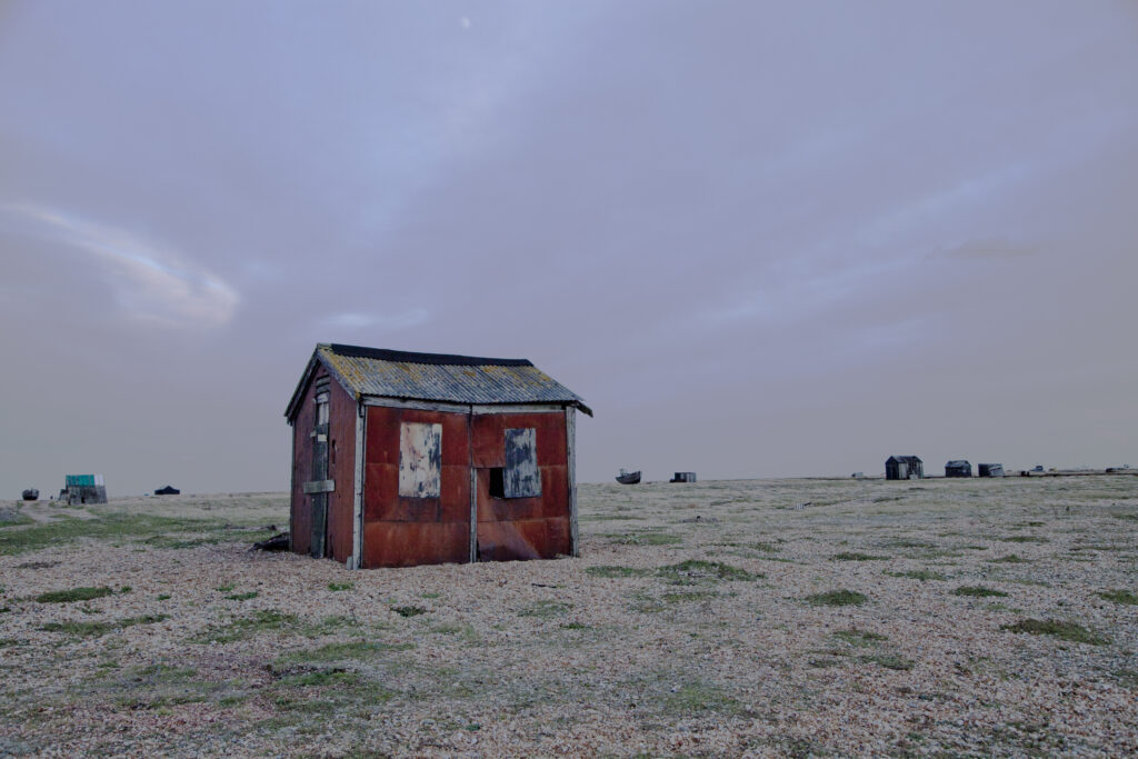 Shed on shingle beach with big sky