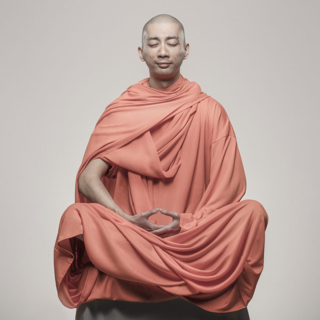 Budist Monk, cross legged, meditating