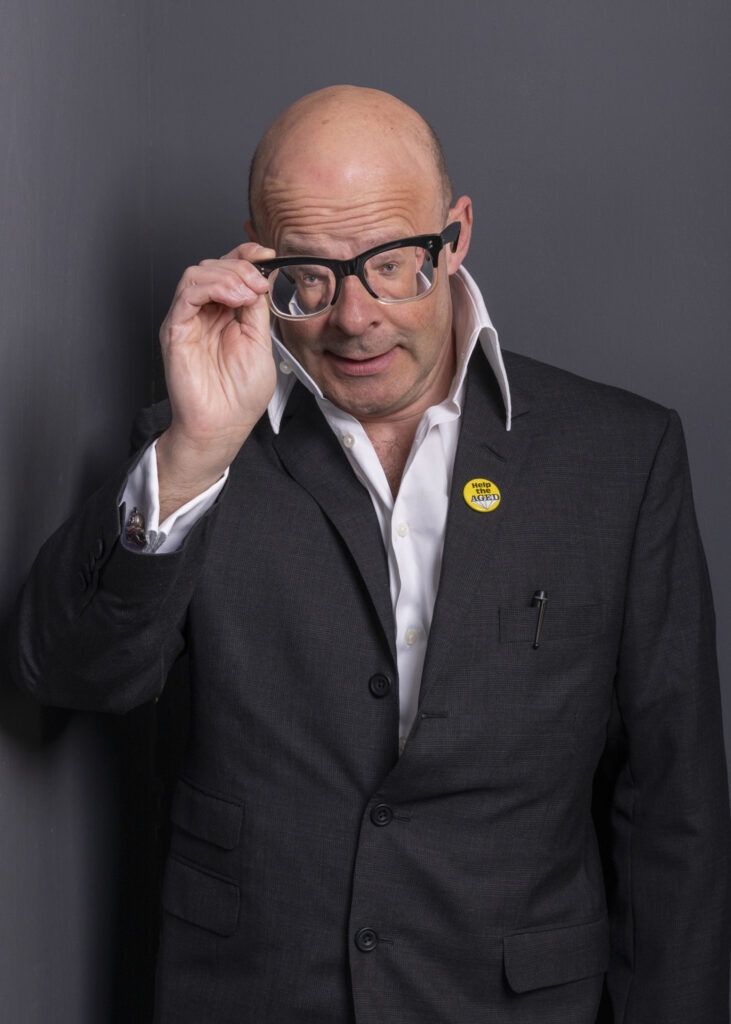 !Harry Hill - looking to camera through his Glasses away from his face - distorting him