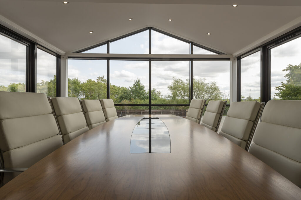 Meeting room with green trees and sky background empty desk