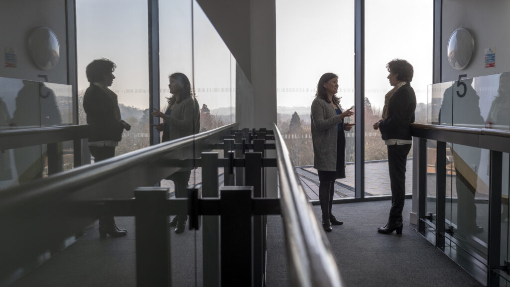 two ladies chatting in Office building,