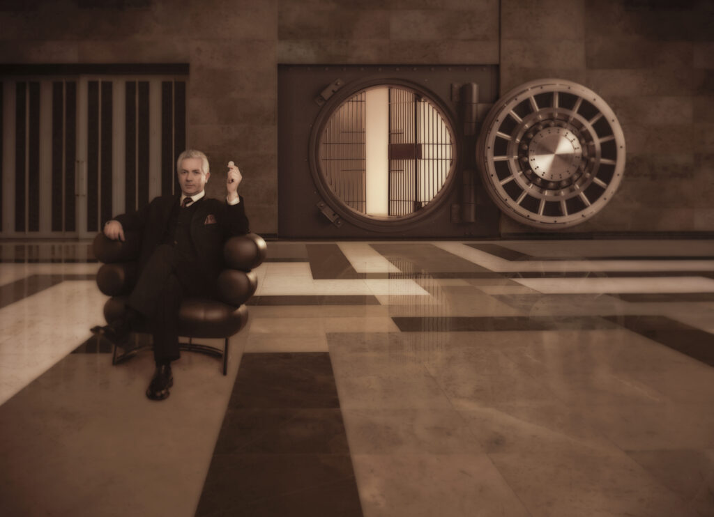 banker in chair in front of a vault safe