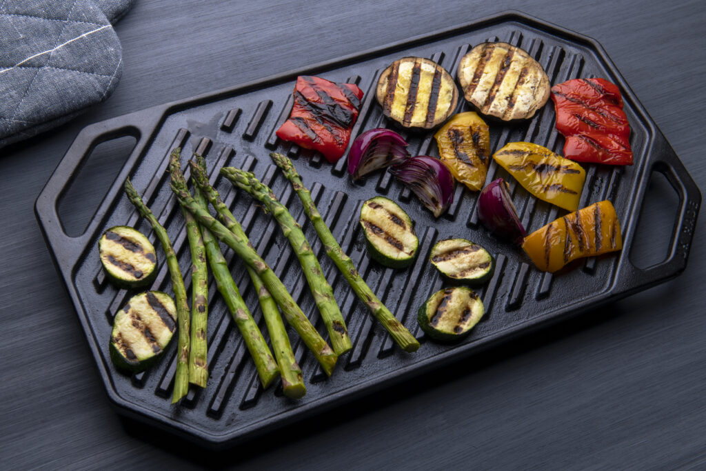 cooked and char marked vegetables on cast iron griddle
