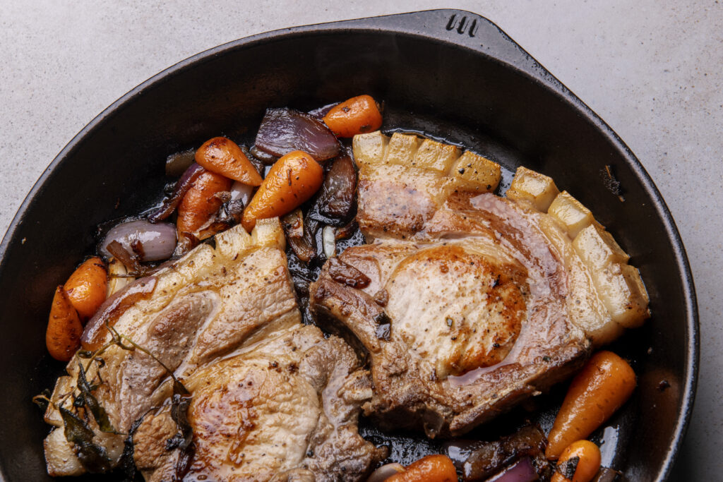 pork chop and veg detail in skillet