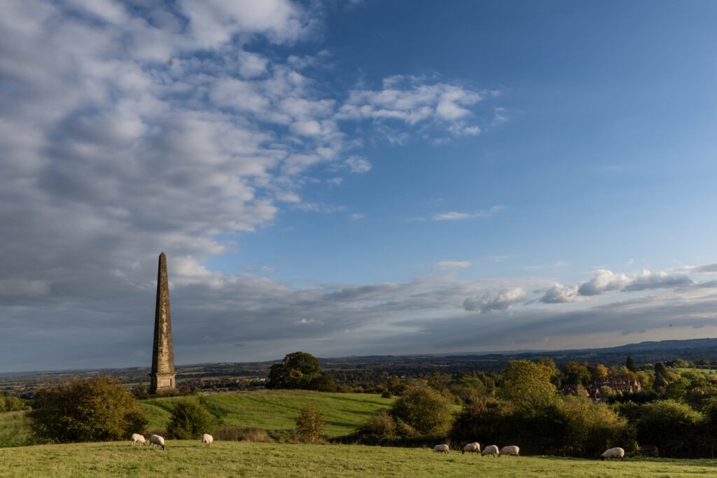 Obelisk on Hill with sheep and big sky