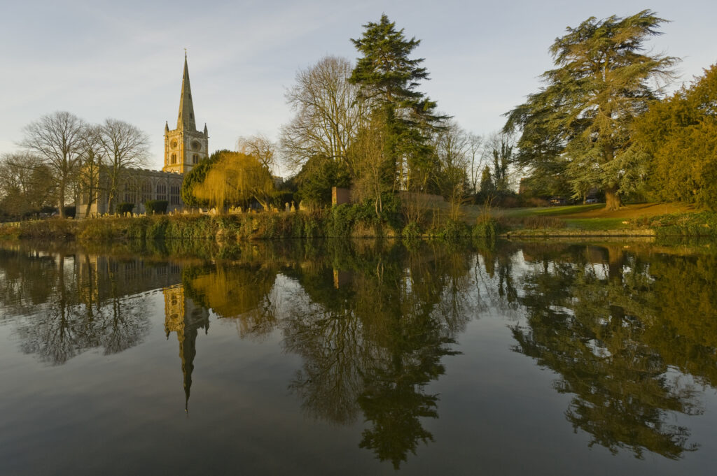 Trinity Church refected in Avon with Autumn colours of trees