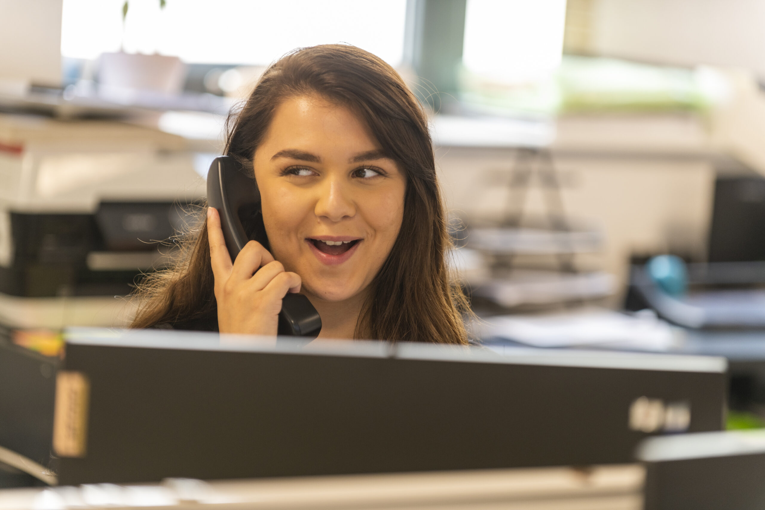 Young lady on phone in office