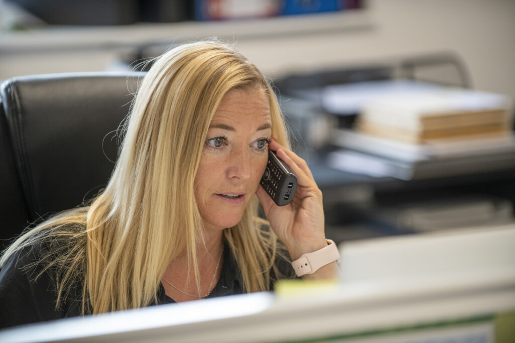 blonde lady on phone in office chatting