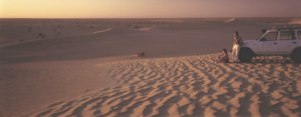 couple in big desert with Land Cruiser