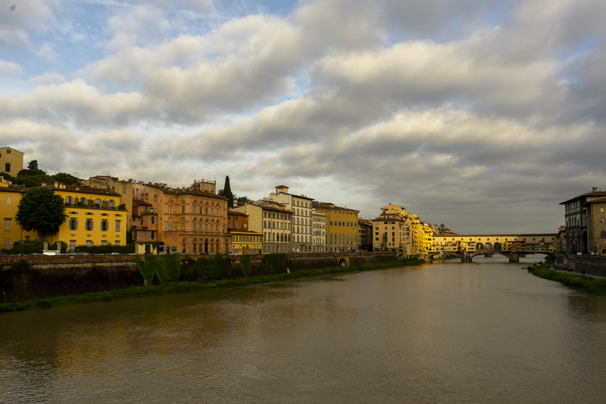 Florence, Ponte Vecchio, from upstream in morning light and dramatic clouds