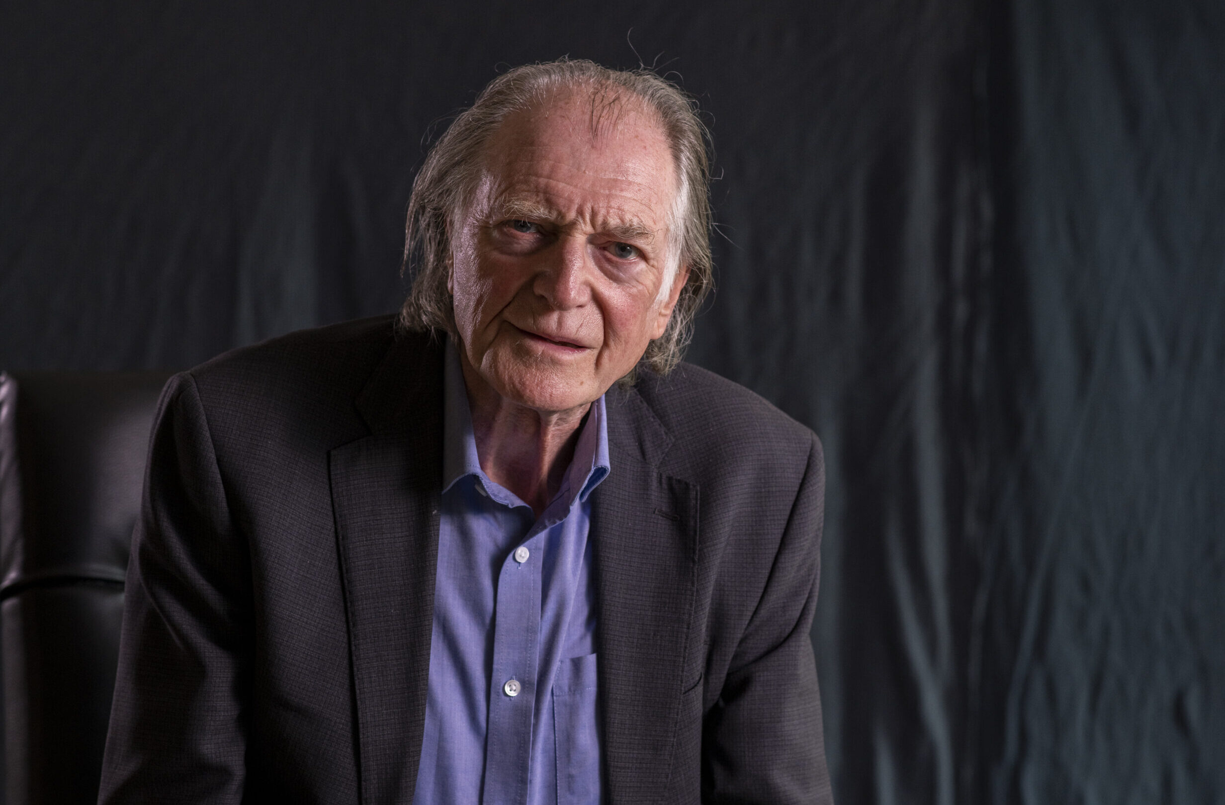 David Bradley, star of Harry Potter, looking to camera, seriously.