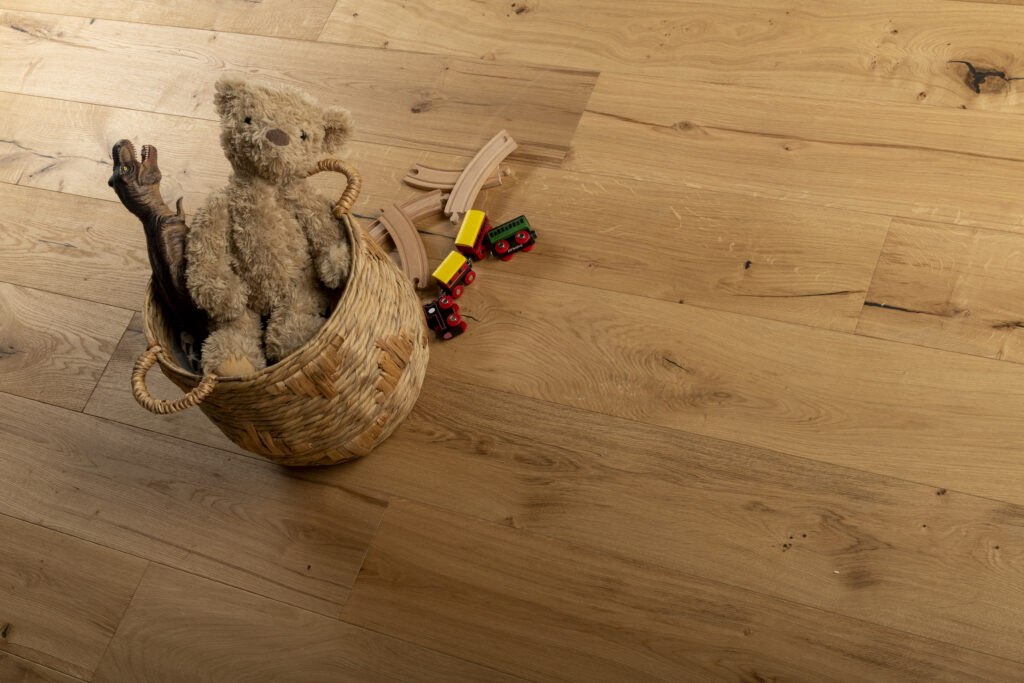 Wooden floor with childs props, toys and teddy