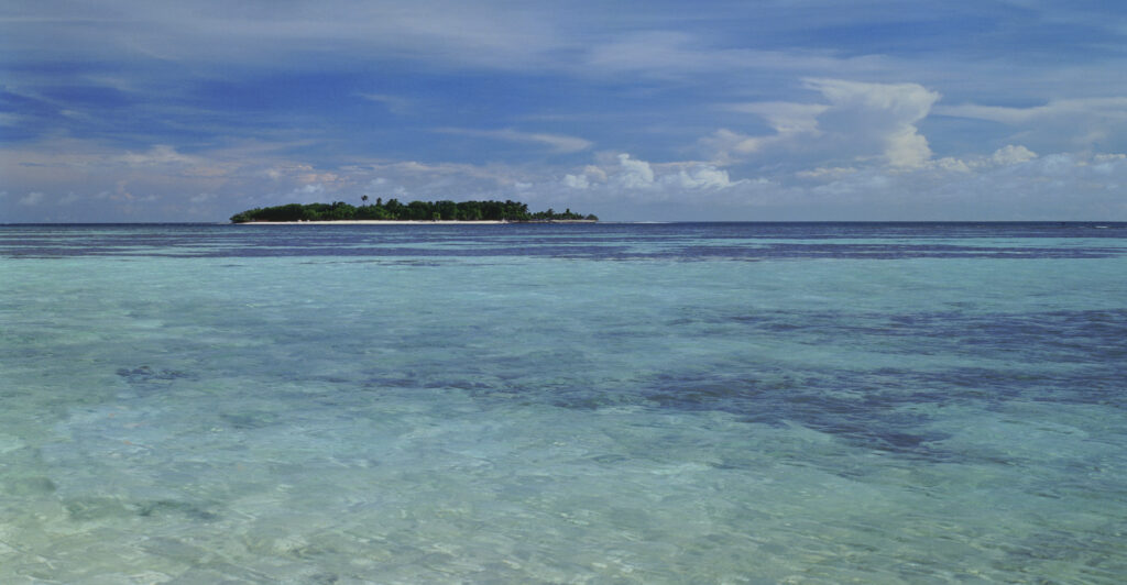 desert Island - Maldives in crystal clear water and blue sky