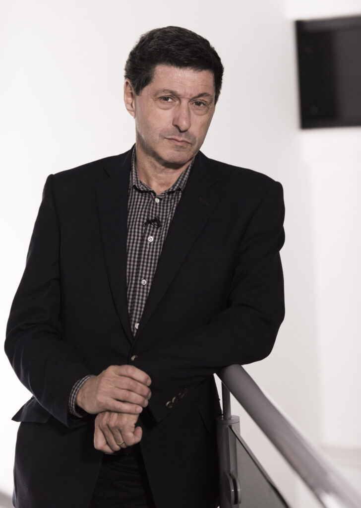 News presenter Jon Sopel leaning on banister. Portrait photograph by Lorentz Gullachsen