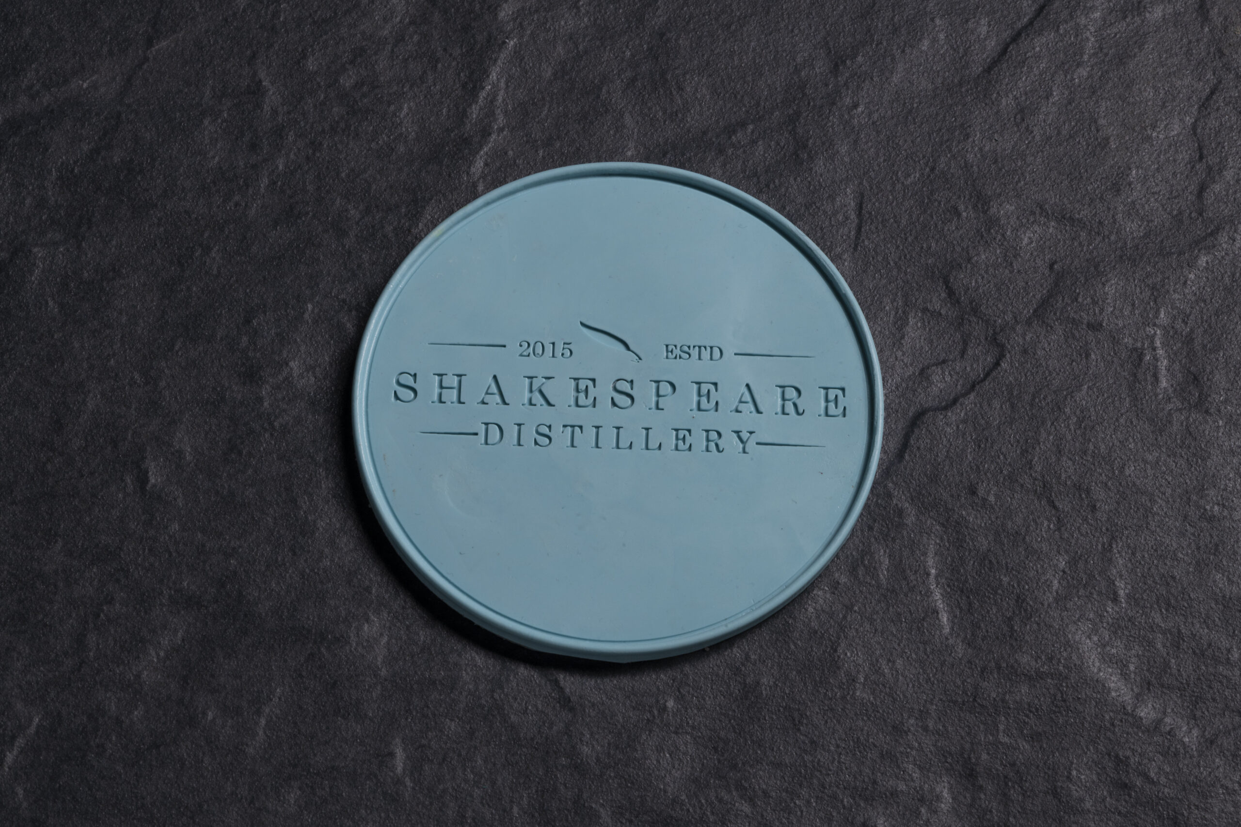 blue drink coaster with log of Shakespeare Distillery - product image